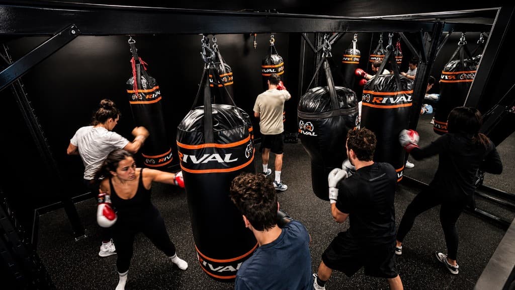 Group boxing class training on heavy bags at SBT Boxing